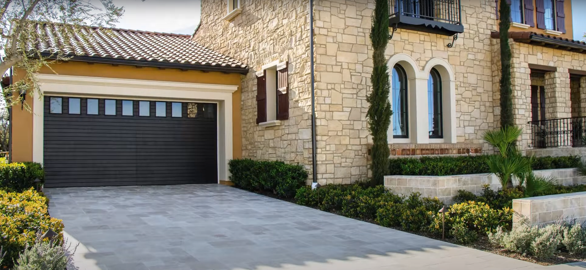 Technician performing same-day garage door repair services on a residential overhead door.