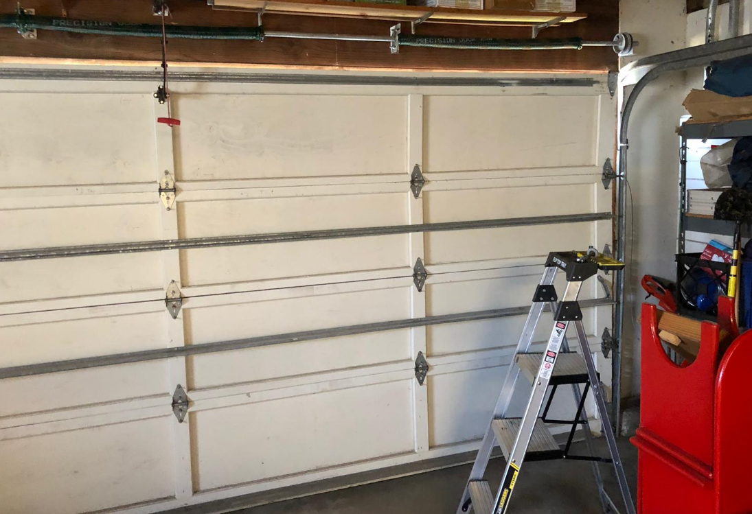 Technician performing garage door repair in Cape Coral, FL - Reliable and professional garage door service.