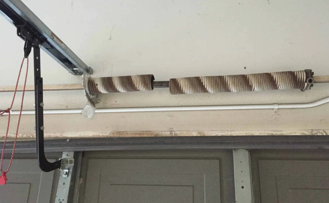 Close-up of a technician performing garage door spring repair in Cape Coral, FL, highlighting tools and safety measures"