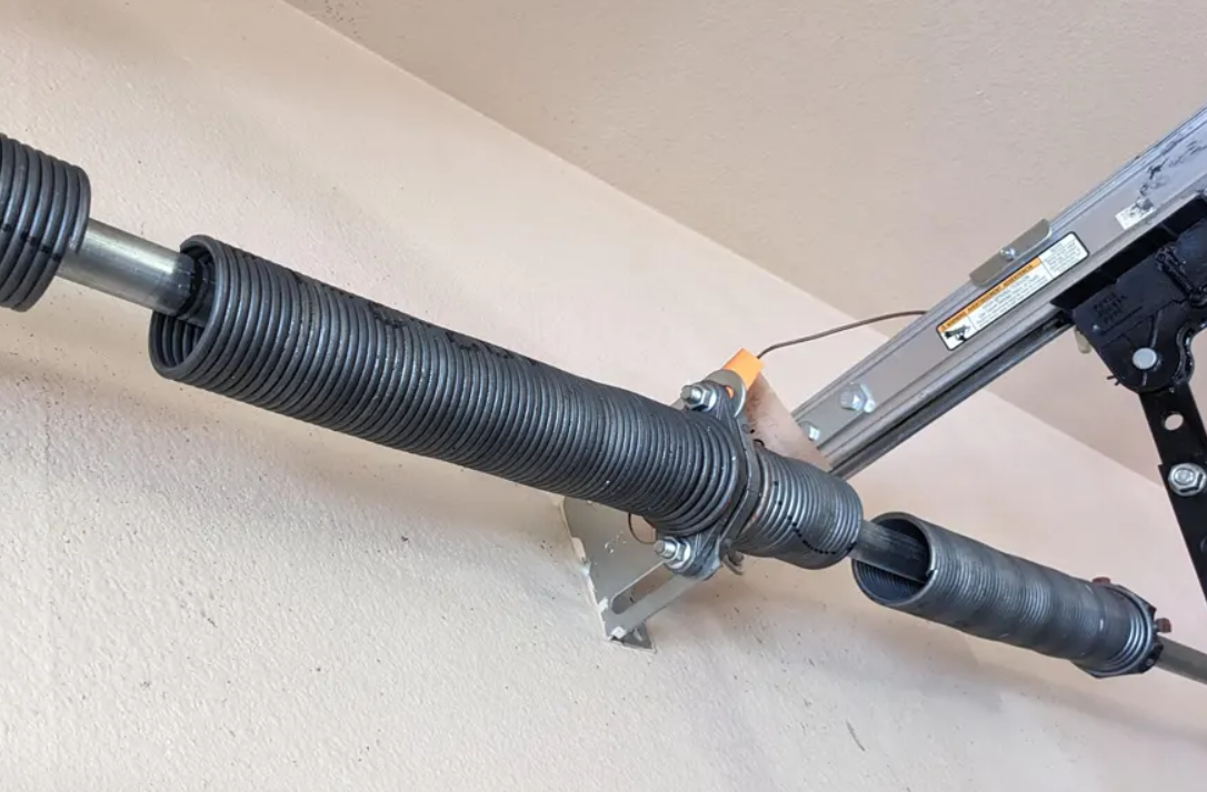 Close-up image of a professional technician repairing a garage door spring in Cape Coral, FL.