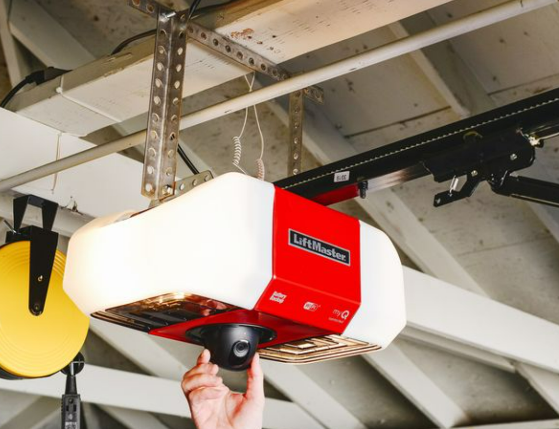 a technician repairing a garage door opener with a set of tools, illustrating professional garage door repair services in Cape Coral, FL.